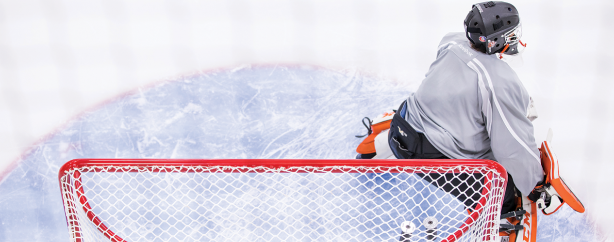 Hockey Goalie In front Of Net On Ice