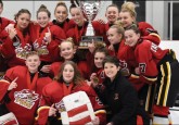 Head Coach of the Calgary Bantam Elite Fire Red, Kelsey Leifson (bottom right) celebrates a Wickfest championship with her team.
