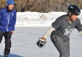Duane Moleni (right) works on his skating with Hockey Alberta Foundation Board Vice Chair Dennis Zukiwsky (left).