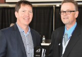 Doug Kinsella (left), accepts the Chairman of the Board award from Terry Engen during Hockey Alberta’s Annual General Meeting
