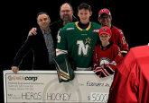 Image: Team Alberta Goaltender Ryley Budd stands with his Heroes Hockey cheque.