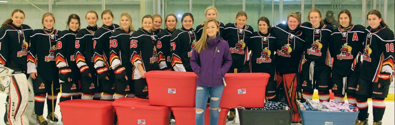 The Lloydminster PWM Steelers present 513 pairs of pajamas to Olivia Brockhoff for Project PJ
